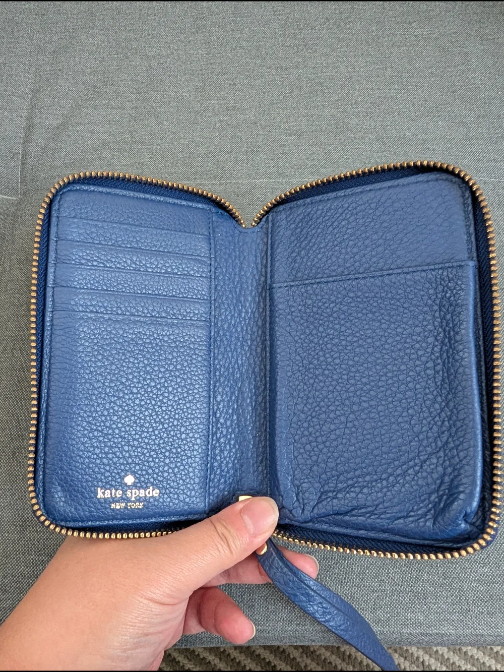 kate spade pebbled cobalt blue wristlet with gold logo